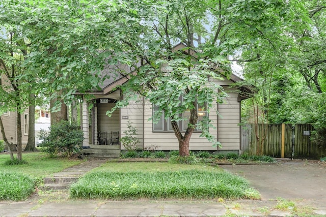 1151 Central Ave, Memphis, TN 38104 - view of property hidden behind natural elements with a front yard and fence