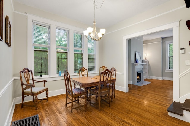 1151 Central Ave, Memphis, TN 38104 - dining area featuring a fireplace with flush hearth, wood finished floors, and a healthy amount of sunlight