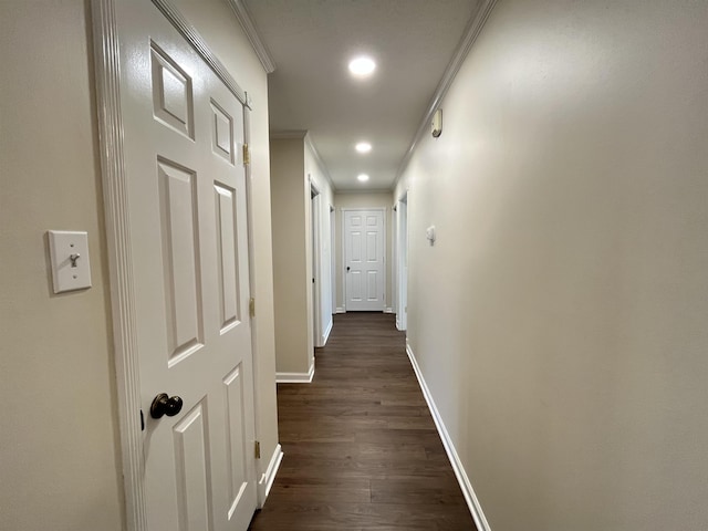 corridor featuring baseboards, dark wood-type flooring, crown molding, and recessed lighting