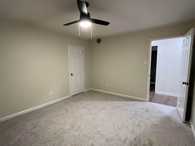 unfurnished bedroom with light carpet, ceiling fan, and baseboards