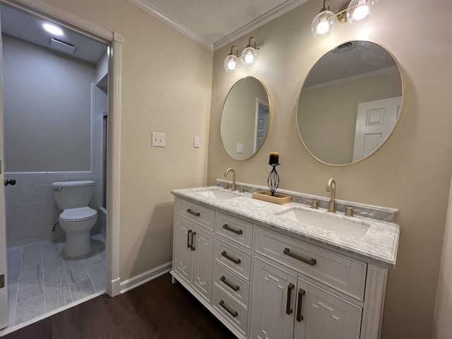 full bath featuring crown molding, a sink, toilet, and wood finished floors