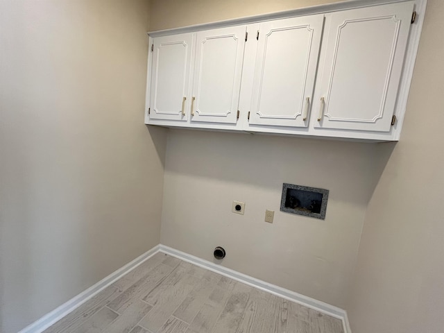 clothes washing area featuring cabinet space, light wood finished floors, baseboards, washer hookup, and electric dryer hookup