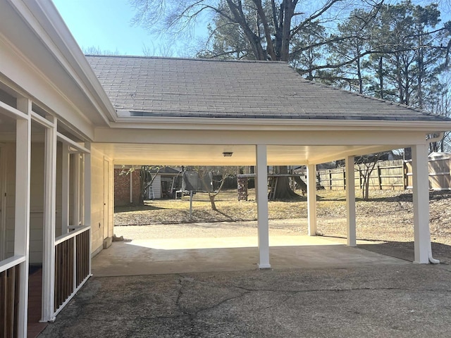 view of patio / terrace with driveway and an attached carport