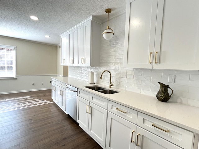 kitchen with dark wood finished floors, hanging light fixtures, a sink, white cabinetry, and stainless steel dishwasher