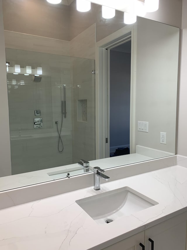 full bathroom with a shower stall and vanity