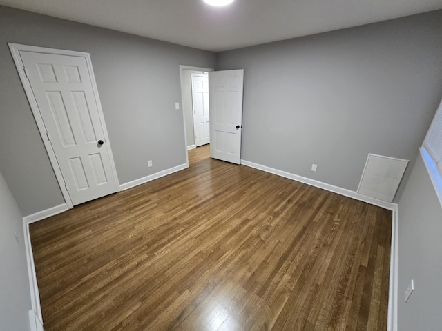 unfurnished bedroom with baseboards and wood finished floors