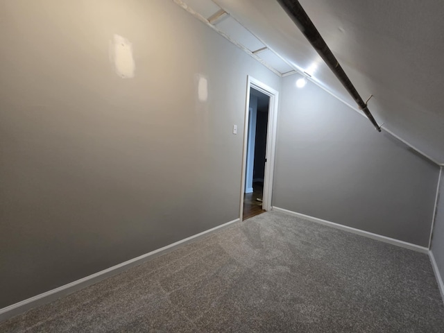 carpeted spare room featuring baseboards