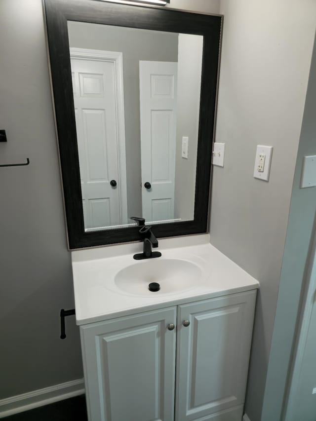 bathroom with vanity and baseboards