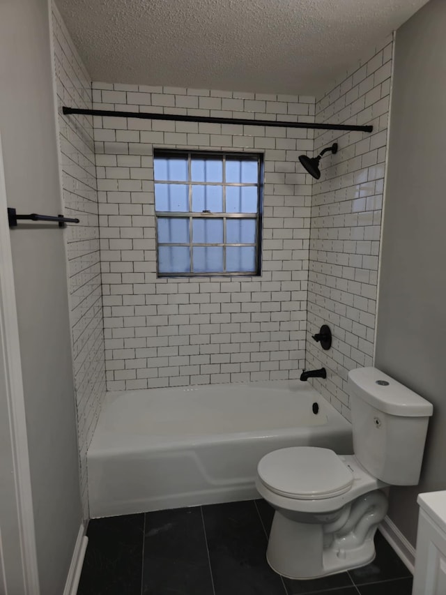 bathroom featuring a textured ceiling, toilet, bathing tub / shower combination, baseboards, and tile patterned floors