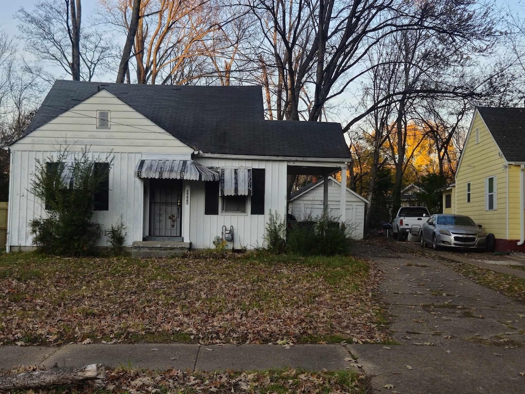 bungalow-style house featuring board and batten siding and an outdoor structure