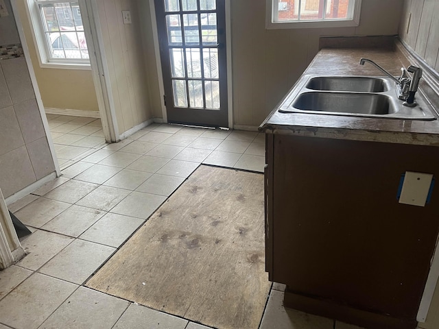 kitchen featuring a sink and light tile patterned flooring