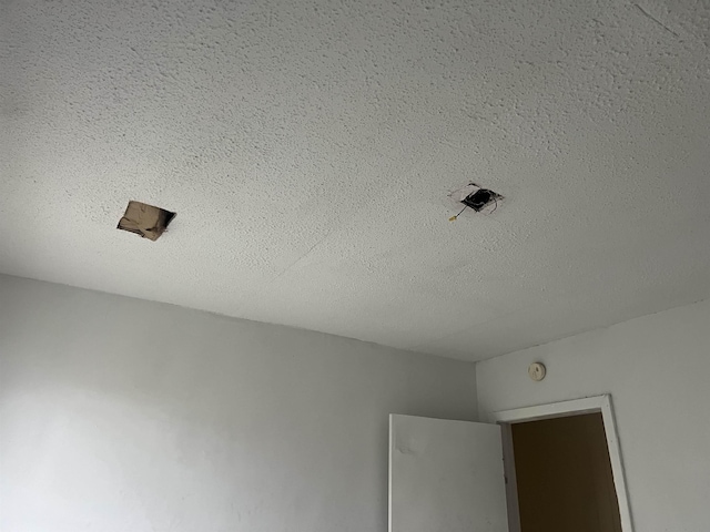 interior details featuring a textured ceiling