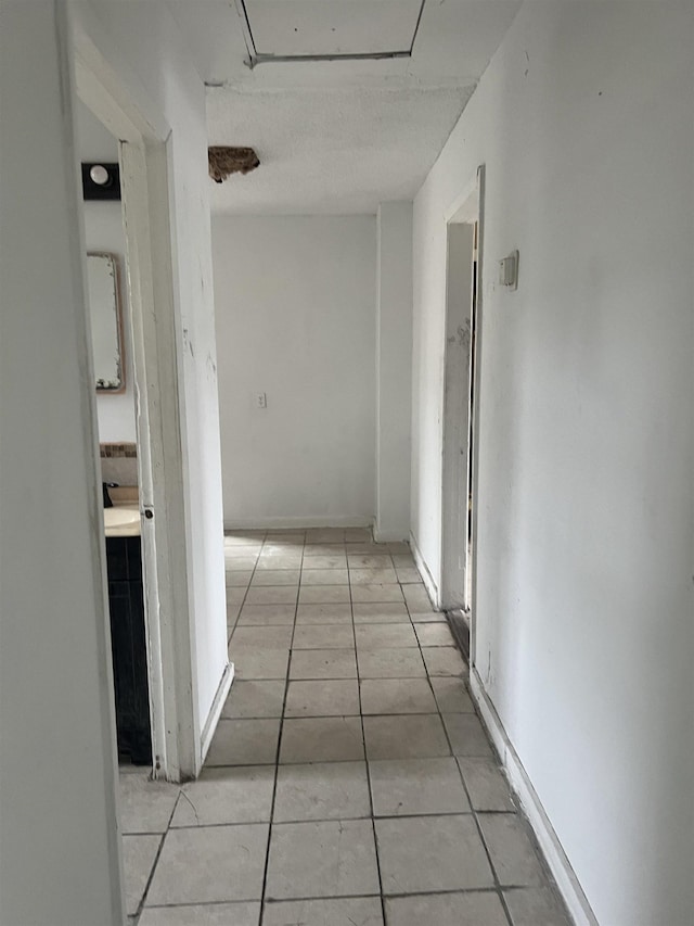 hallway featuring light tile patterned floors