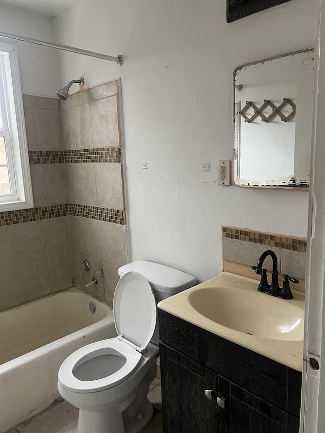 bathroom featuring toilet,  shower combination, backsplash, and vanity