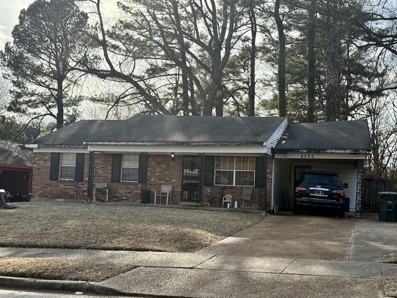 ranch-style house featuring crawl space, a carport, concrete driveway, and brick siding