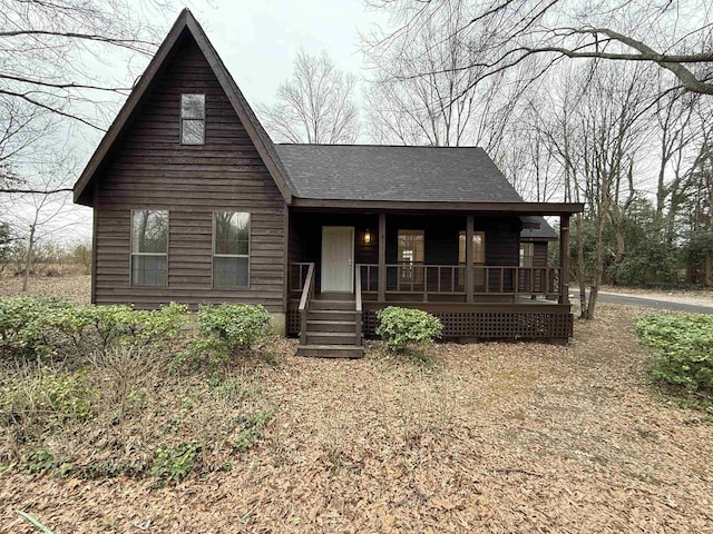 view of front of house with covered porch and roof with shingles