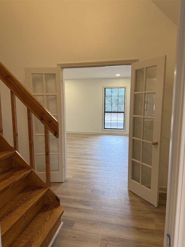 hallway featuring stairs and light wood finished floors