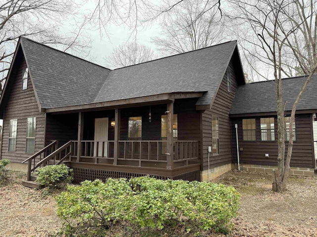 view of front of house featuring covered porch, crawl space, and roof with shingles