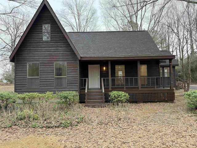 view of front facade with a porch and roof with shingles