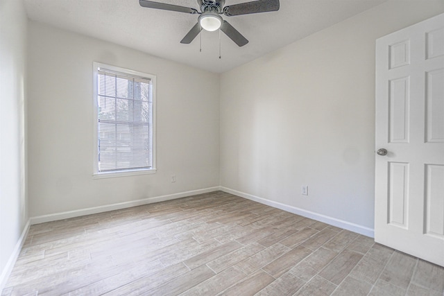 unfurnished room with light wood-style floors, ceiling fan, and baseboards