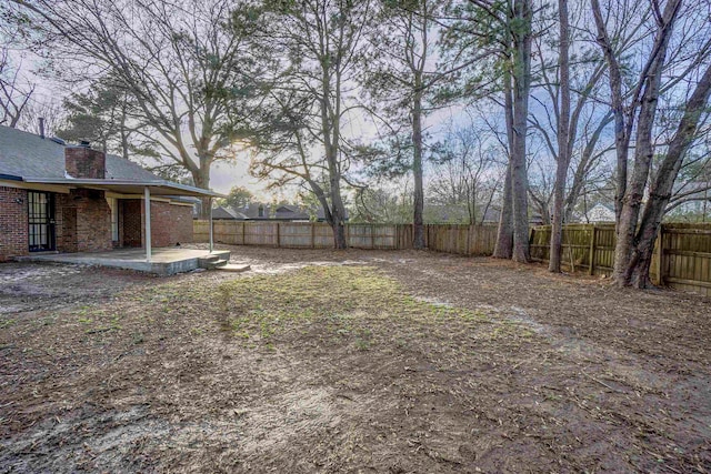 view of yard featuring a patio and a fenced backyard