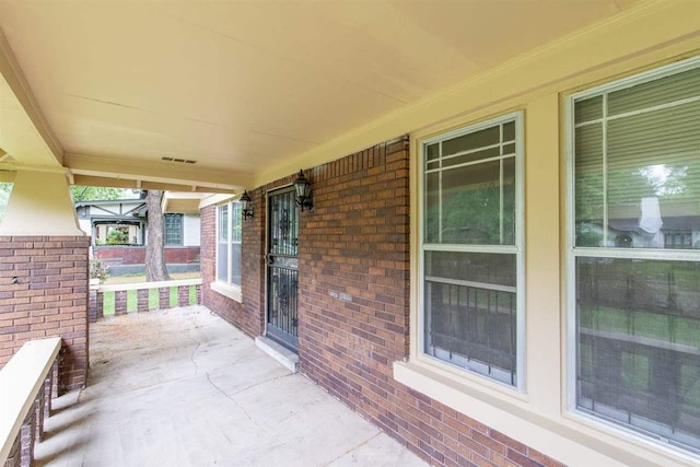 view of patio featuring covered porch and visible vents