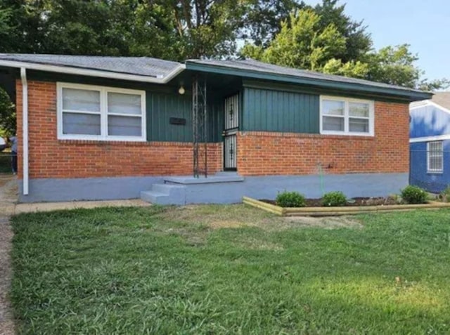 single story home with brick siding and a front lawn