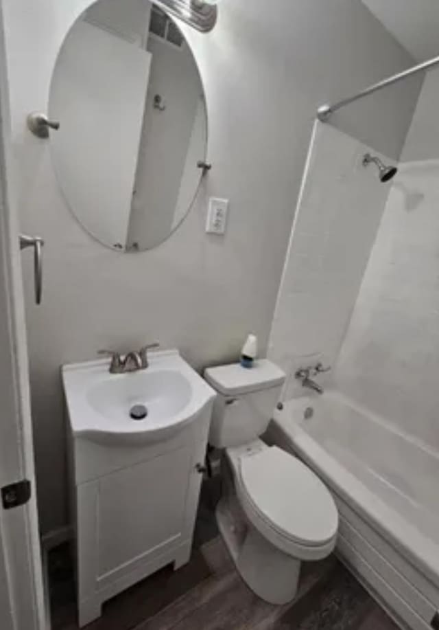 full bathroom with shower / washtub combination, vanity, toilet, and wood finished floors