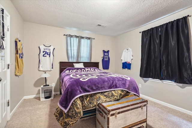 carpeted bedroom featuring visible vents, baseboards, and a textured ceiling