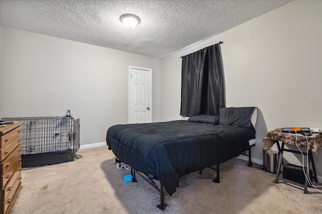 bedroom featuring carpet flooring, a textured ceiling, and baseboards