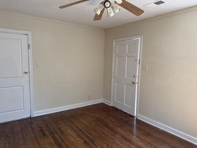 spare room featuring dark wood-style floors, a textured ceiling, and crown molding