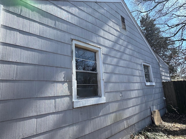 view of property exterior featuring fence