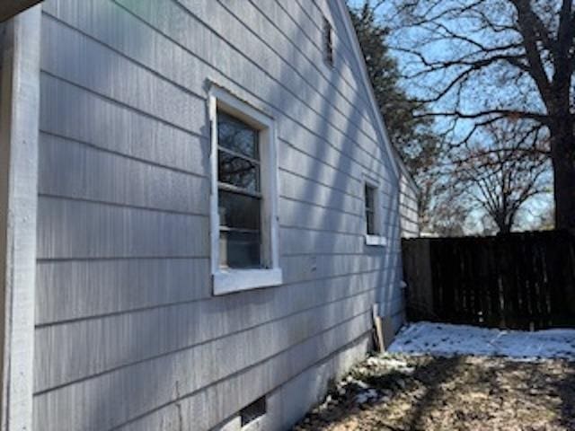 view of side of property featuring fence