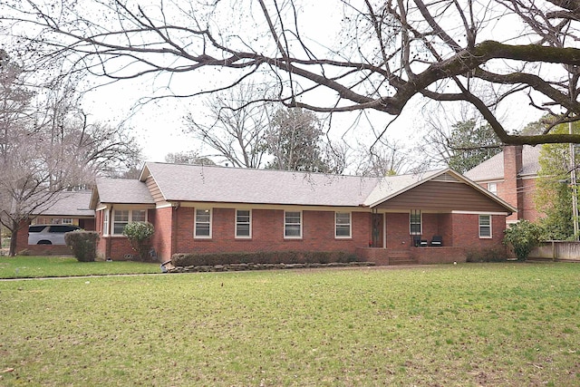 ranch-style home with roof with shingles, brick siding, crawl space, and a front lawn