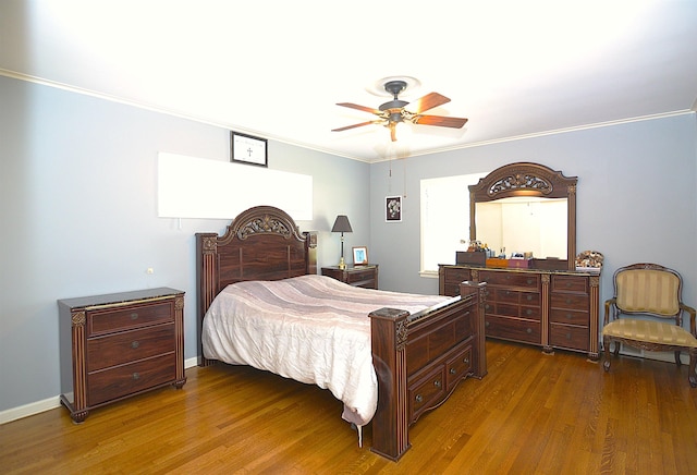 bedroom featuring ornamental molding, a ceiling fan, baseboards, and wood finished floors