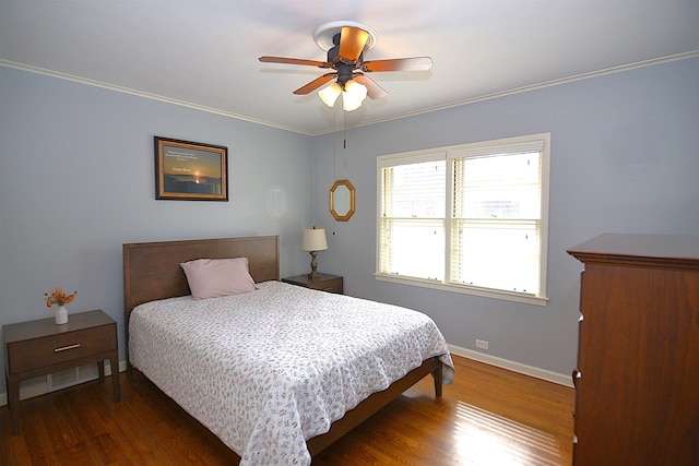 bedroom featuring crown molding, dark wood finished floors, baseboards, and ceiling fan