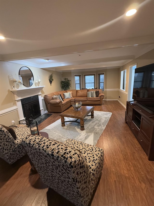 living room with a fireplace, baseboards, wood finished floors, and recessed lighting