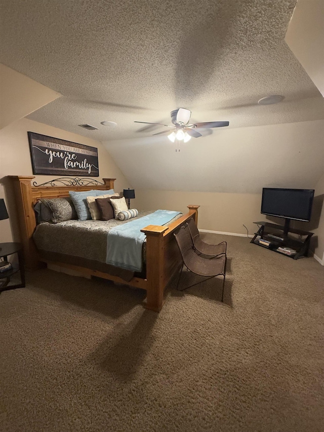 bedroom with lofted ceiling, carpet floors, a textured ceiling, and a ceiling fan