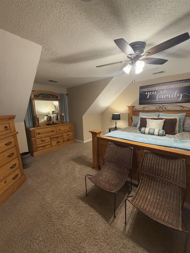 bedroom with a textured ceiling, carpet floors, ceiling fan, and visible vents