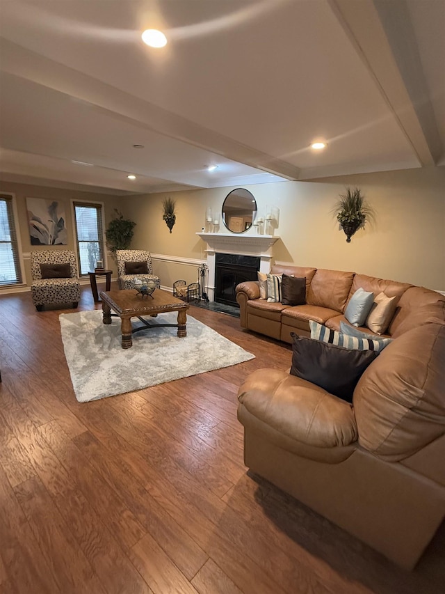 living area with a fireplace, wood finished floors, beam ceiling, and recessed lighting