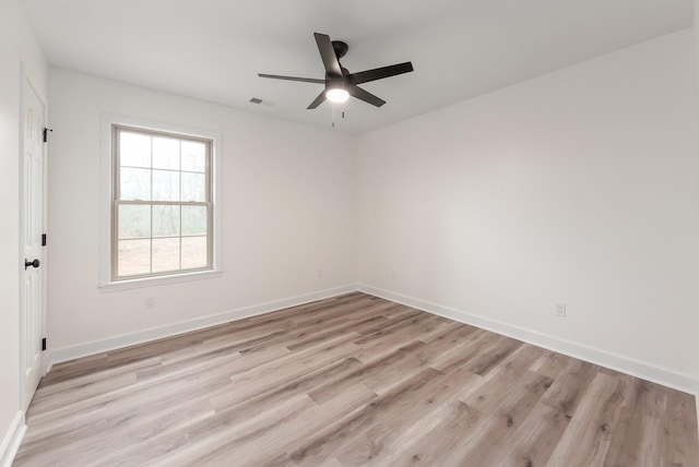 empty room with light wood-style floors, visible vents, ceiling fan, and baseboards