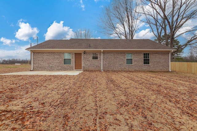 back of house with a patio area, brick siding, and fence