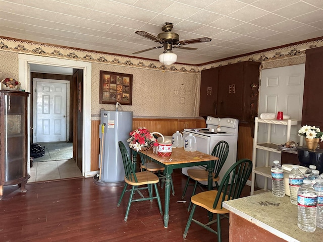 dining space with ceiling fan, dark wood-type flooring, water heater, washer / clothes dryer, and wallpapered walls