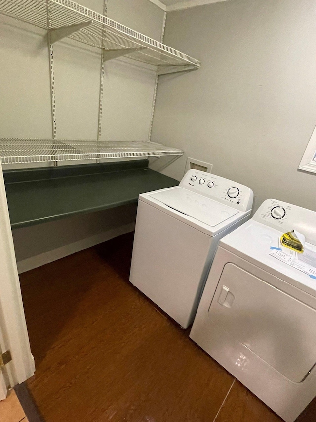 laundry room with dark wood-style floors, laundry area, and washer and clothes dryer