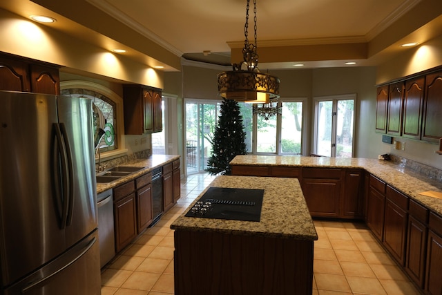 kitchen with pendant lighting, crown molding, stainless steel appliances, a kitchen island, and a peninsula