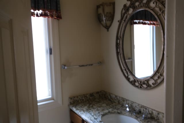 bathroom featuring a wealth of natural light and vanity