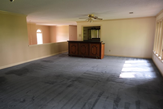 carpeted empty room featuring a ceiling fan, visible vents, ornamental molding, and baseboards