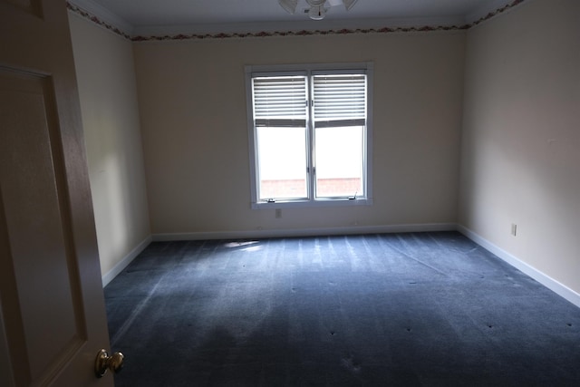 unfurnished room with dark colored carpet and baseboards