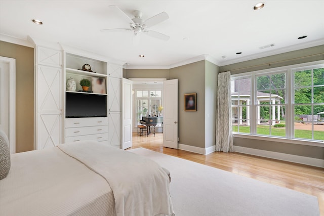 bedroom with light wood-type flooring, baseboards, visible vents, and crown molding