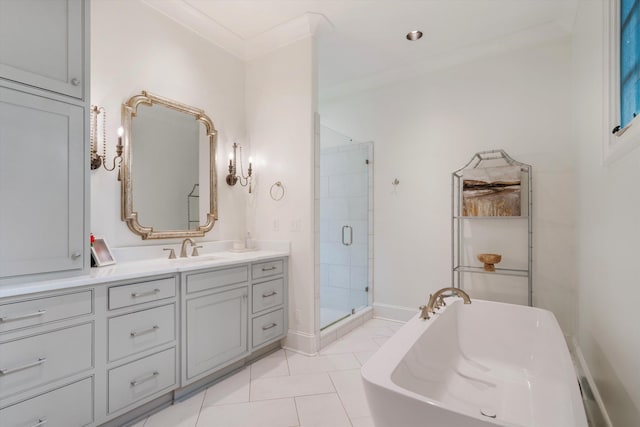 bathroom featuring vanity, baseboards, a freestanding bath, a shower stall, and crown molding